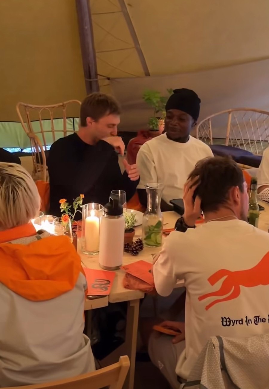 Guests at a candlelit dinner inside a tent